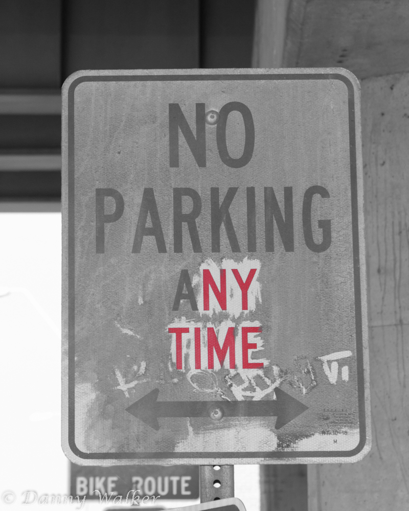 A no parking sign with red letters NY and Time.