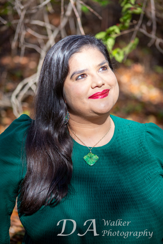 Young hispanic woman looking into the sun.